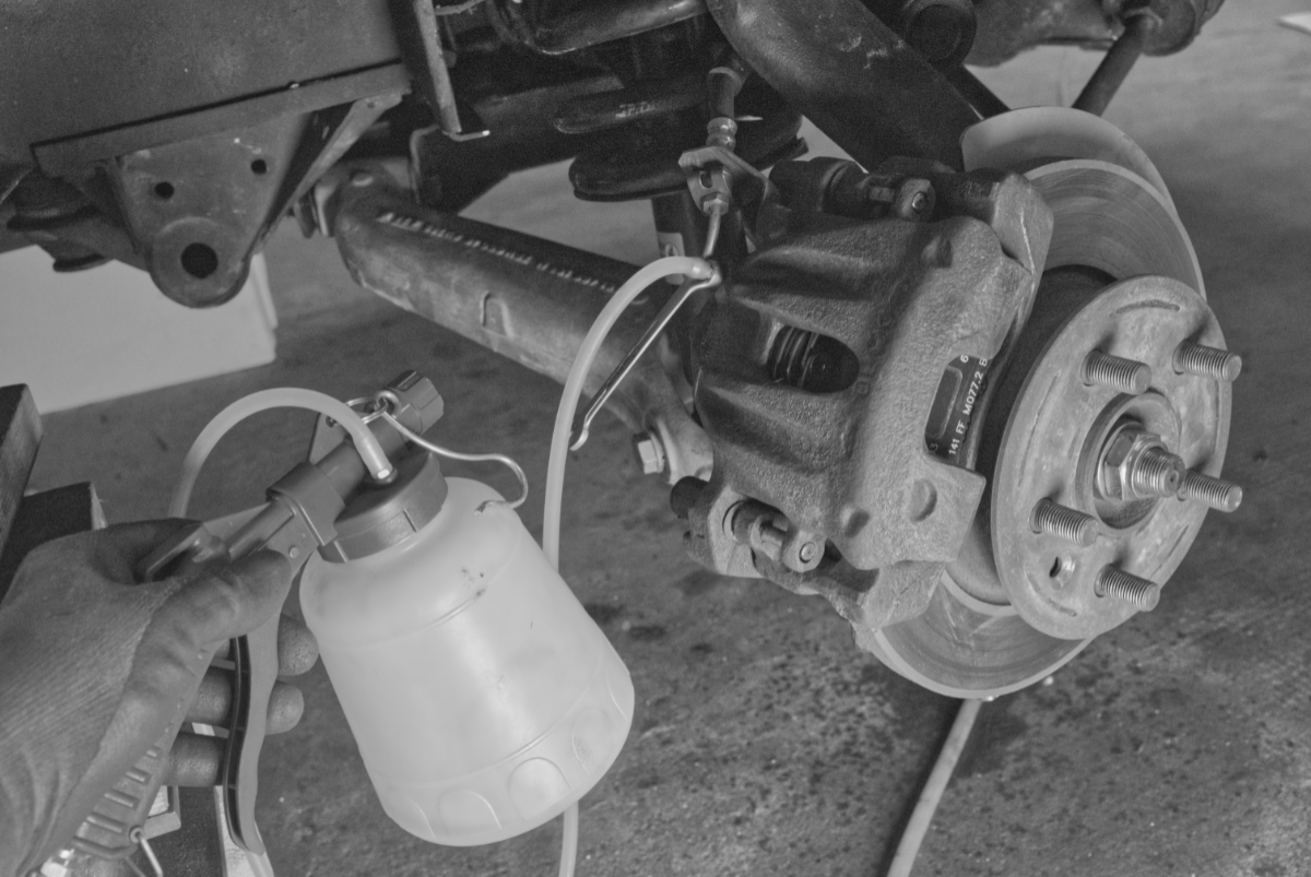 Bremssattel mit einer Unterdruckpumpe entlüften